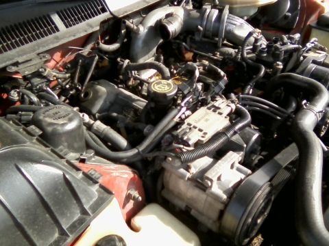1999 Mercury Grand Marquis - Close-up view of a complex engine bay with various mechanical parts and wiring.
