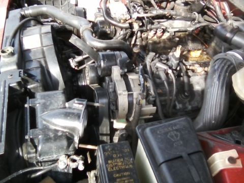 1999 Mercury Grand Marquis - Close-up view of a car's engine bay, showing various mechanical parts and hoses.