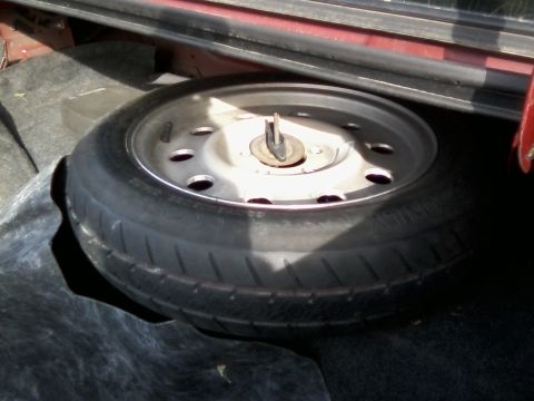 1999 Mercury Grand Marquis - The spare tire is secured in the trunk with a central mounting bolt.