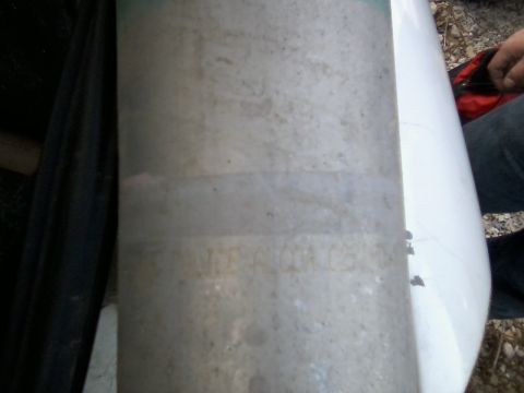 1999 Mercury Grand Marquis - A driveshaft is shown in this close-up photo, with some faded text on its surface.