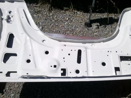 1982 Ford Bronco - A white painted section of a vehicle frame, likely from the engine bay area, is shown with many holes and cutouts.