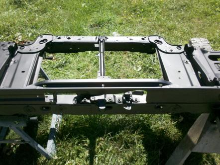1982 Ford Bronco - Vehicle frame section shown outdoors on sawhorses.