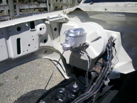 1982 Ford Bronco - Close-up view of a vehicle's engine bay, showing the brake system components and wiring.