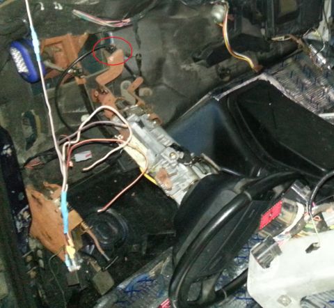 1994 Ford Bronco - The dashboard and wiring harness of a vehicle are exposed, showing a complex network of cables.
