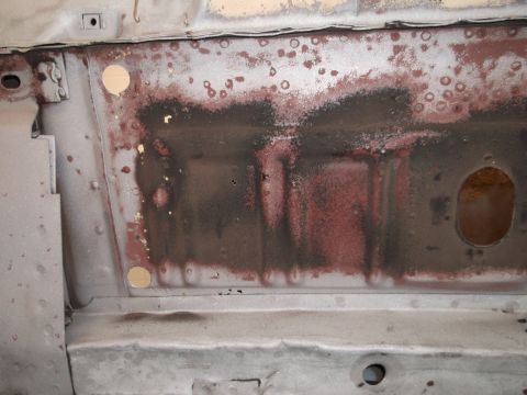 1967 Ford Mustang - Close-up of a heavily rusted metal panel, likely from a car's undercarriage or body.
