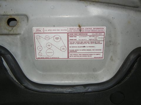 1999 Ford Fairlane - Engine bay sticker details drive belt routing and emission control for a Ford 5.0L MPEFI engine.