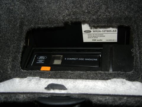 1999 Ford Fairlane - A Ford 6-disc CD changer magazine is visible in a compartment.