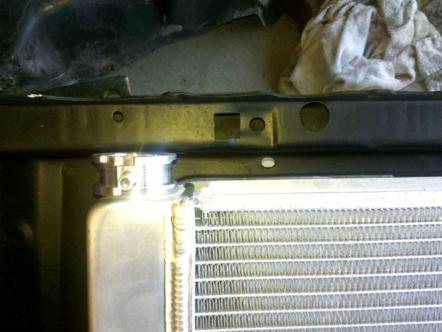 1982 Ford Bronco - Close-up view of a vehicle's radiator and surrounding engine bay components.