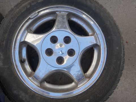 1993 Ford Taurus - Close-up of a single chrome wheel and tire assembly.