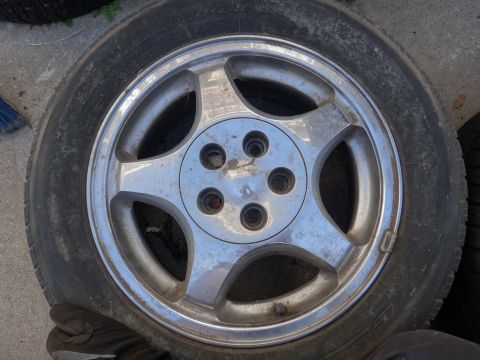 1993 Ford Taurus - A single wheel and tire are shown, with no visible vehicle body.