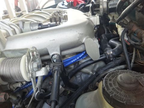 1993 Ford Taurus - Close-up view of an engine bay, showing intricate mechanical components and hoses.