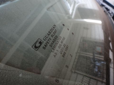1993 Ford Taurus - Close-up of windshield glass with manufacturer and safety certifications visible.