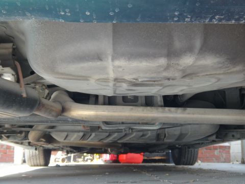 1993 Ford Taurus - Underside view of a vehicle, focusing on the exhaust system and fuel tank components.