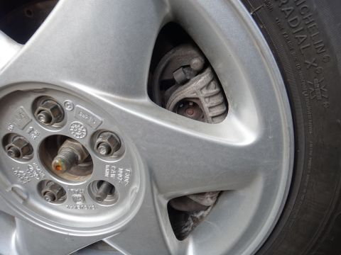 1993 Ford Taurus - Close-up of a vehicle's wheel and brake system, showing the tire and caliper.
