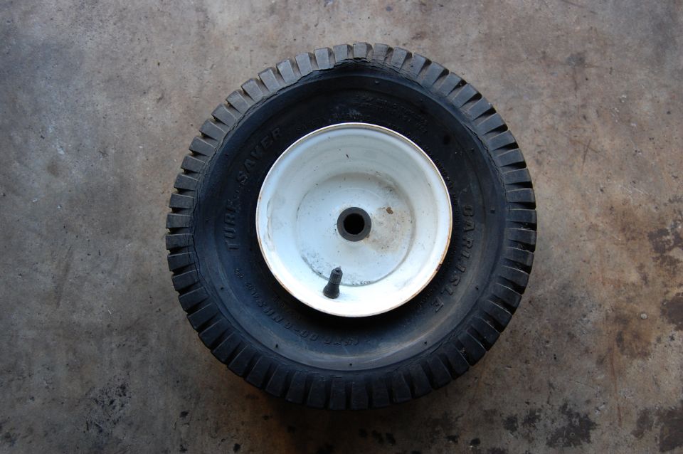 Tire and wheel assembly with 'TUBE SAVER' text visible on the tire sidewall