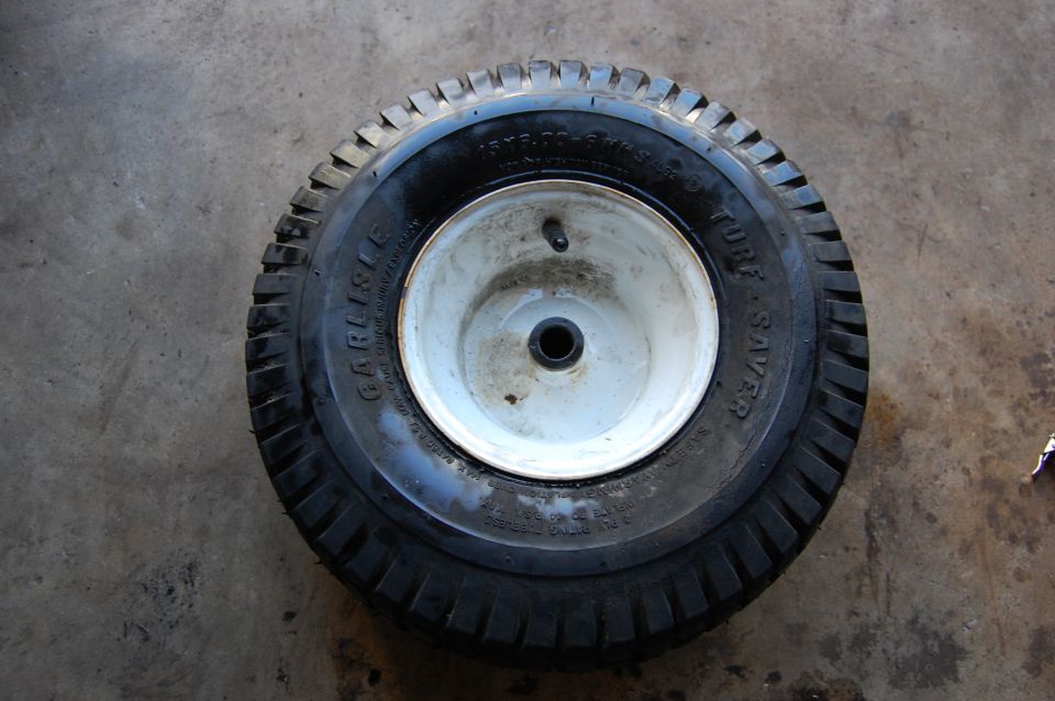 Carlisle Turf Saver tire on a white wheel with a valve stem