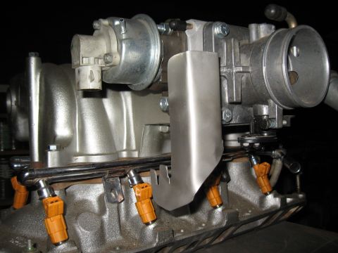 1994 Ford Bronco - Fuel injectors and throttle body assembly from a Ford vehicle.