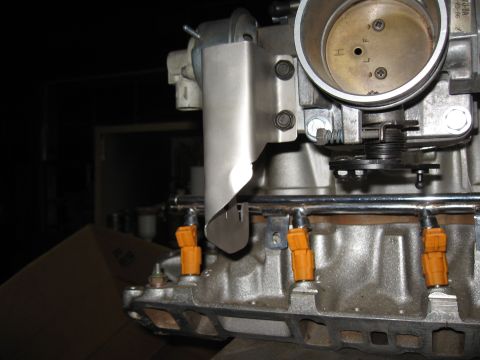 1994 Ford Bronco - Close-up view of engine fuel injectors and throttle body assembly.