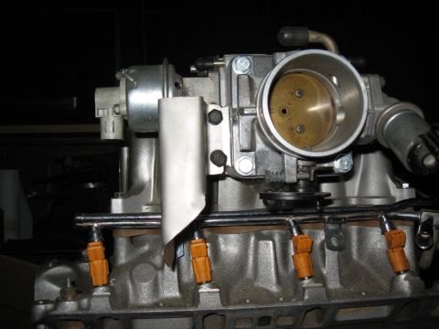 1994 Ford Bronco - Close-up view of engine components including the throttle body and fuel injectors.