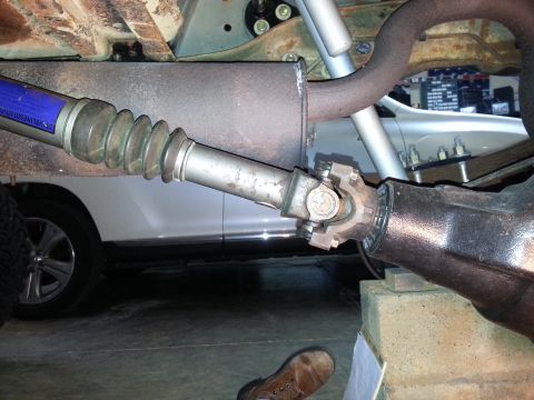 1995 Ford Bronco - Driveshaft and differential assembly shown from underneath a vehicle.