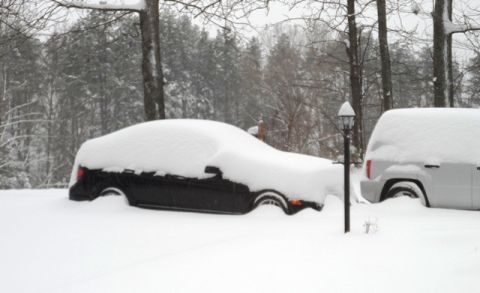 1971 Ford Ranchero - A winter scene shows two vehicles completely covered in a thick blanket of snow.