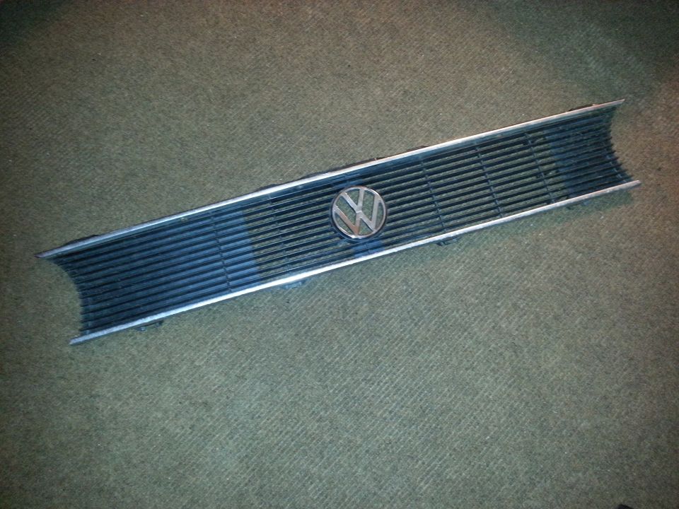 Volkswagen grille with emblem on a carpeted surface