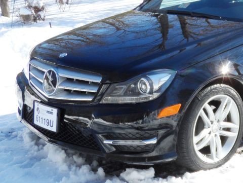 1971 Ford Ranchero - Front view of a black Mercedes-Benz C-Class in a snowy environment, showing the grille and headlights.