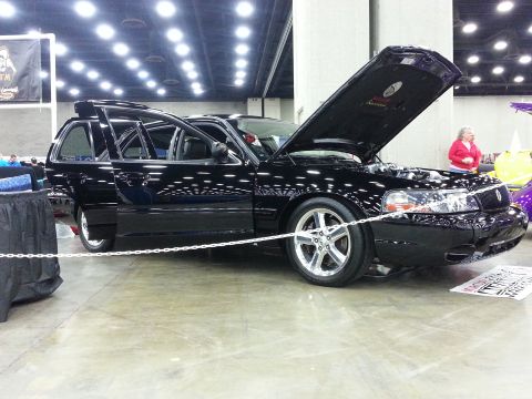 2003 Mercury Marauder - A black 2003 Mercury Marauder wagon is displayed with its doors and hood open at a car show.