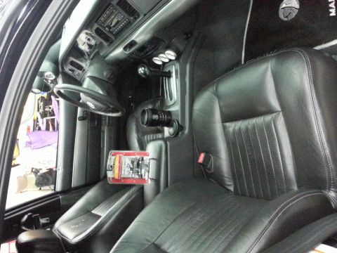 2003 Mercury Marauder - The interior of a custom vehicle features black leather seats and floor mats with a 'Marauder' logo visible.