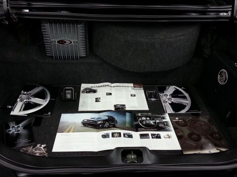 2003 Mercury Marauder - Brochures and an amplifier are displayed in the trunk of a car.