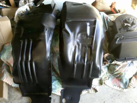 1982 Ford Bronco - Two black plastic fender liners are shown, likely for a vehicle's engine compartment.