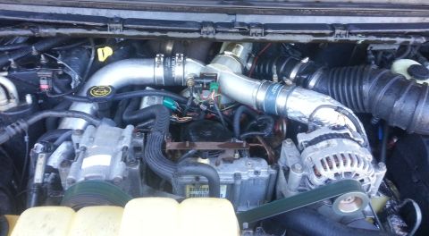 2001 Ford Excursion - Close-up view of an engine bay, showing various components and piping.