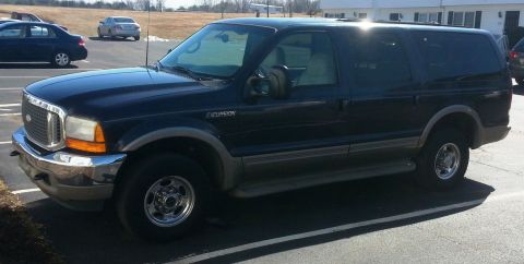 2001 Ford Excursion - This Ford Excursion is parked in a lot with other vehicles visible in the background.