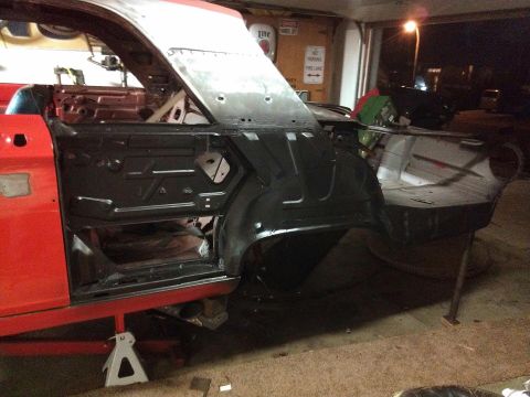 1964 Ford Fairlane - This 1964 Ford Fairlane is undergoing restoration, showing its red exterior and open door revealing the interior structure.