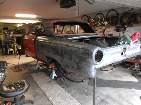 1964 Ford Fairlane - 1964 Ford Fairlane body undergoing restoration in a garage setting.