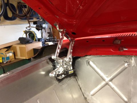 1964 Ford Fairlane - Custom polished hood hinges are installed on a red vehicle with exposed metalwork in the engine bay.