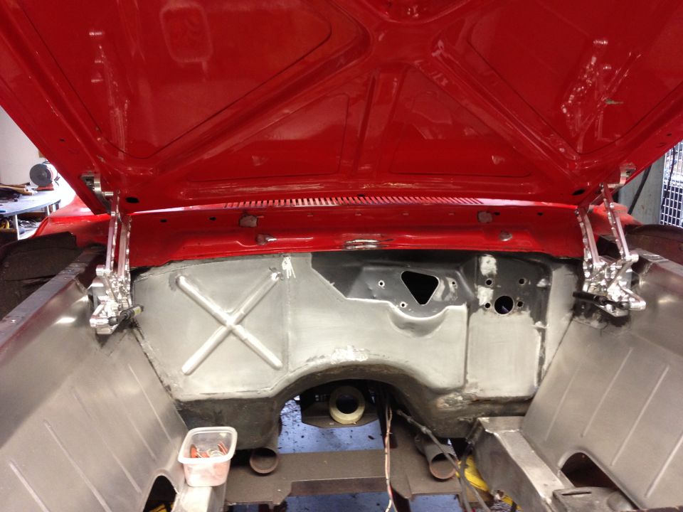 1964 Ford Fairlane engine bay with hood open, showing firewall and inner fenders