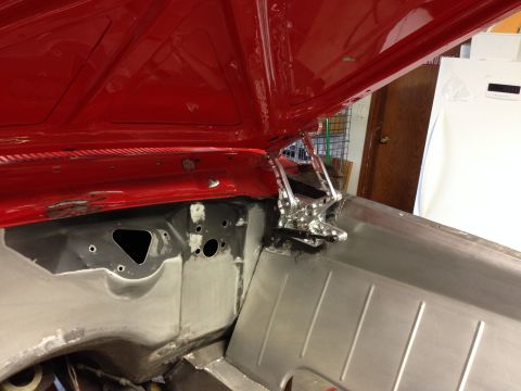 1964 Ford Fairlane - Custom hood hinges are installed in the engine bay of a vehicle undergoing restoration.