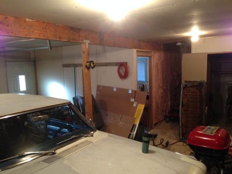 1964 Ford Fairlane - Interior view of a car in a cluttered garage with various items stored around.
