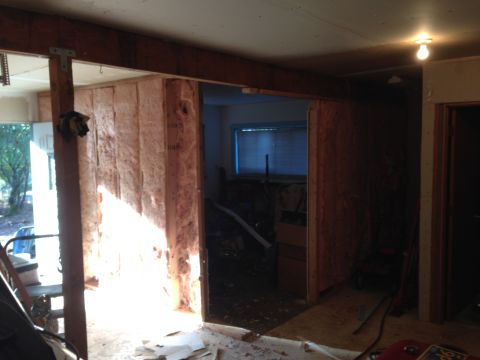 1964 Ford Fairlane - The room is undergoing renovation, with insulation and wooden beams visible.