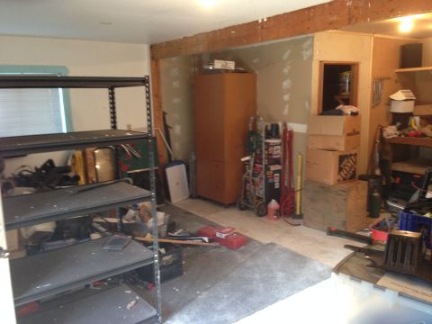 1964 Ford Fairlane - This garage scene is filled with storage shelves, tools, and various items, indicating a workspace or storage area.
