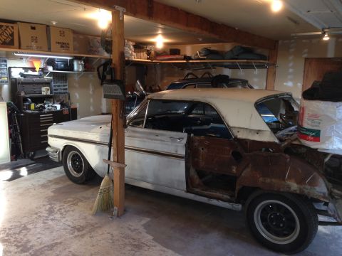 1964 Ford Fairlane - 1964 Ford Fairlane project car in a garage, showing rust and missing body panels.