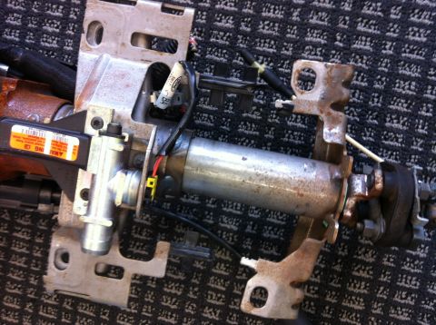 2009 Ford Crown Victoria - Close-up view of a vehicle's steering column assembly, showing mechanical and electrical components.