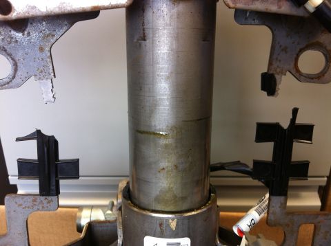 2009 Ford Crown Victoria - Metal steering column part with attached rubber mounts and metal brackets.