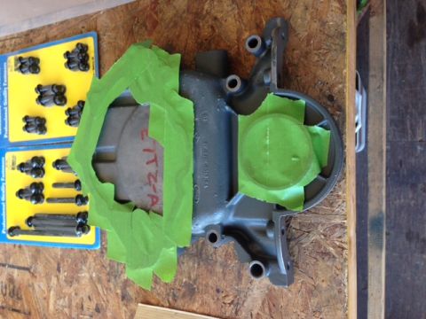 1996 Ford Bronco - A car part is prepped with masking tape, alongside new fasteners for installation.