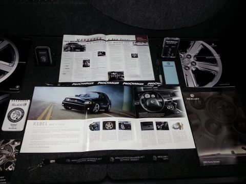 2003 Mercury Marauder - Promotional materials for a 2003 Mercury Marauder are laid out, brochures and a wheel.