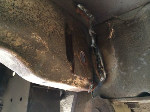 1964 Ford Ranchero - Close-up view of rusted metal frame sections showing welds and debris.