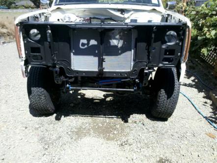 1982 Ford Bronco - Truck front end disassembled, revealing radiator and suspension. Appears to be an early 1980s Ford F-series or Bronco.
