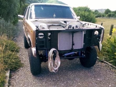 1982 Ford Bronco - This 1982 Ford Bronco is shown from the front with its hood removed, revealing the engine bay components.