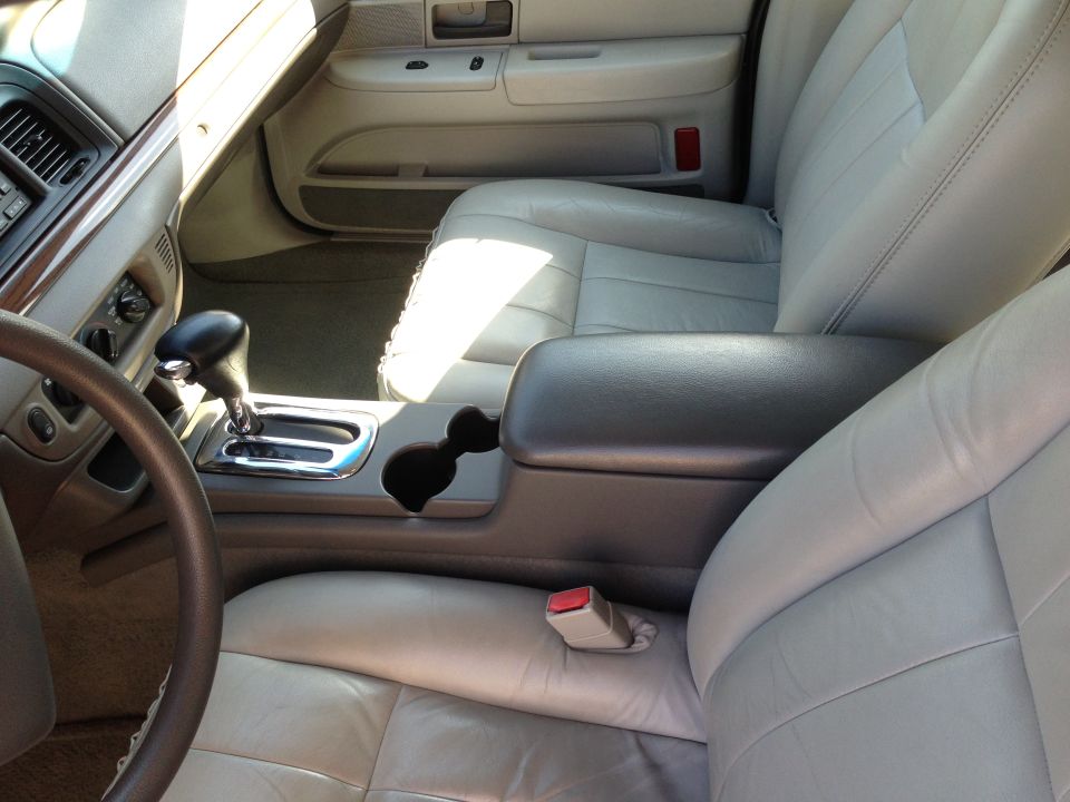 Car interior with light gray leather seats, center console, and gear shifter